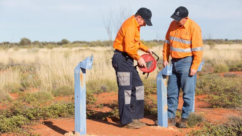 Two workers monitoring water in Yeelirrie